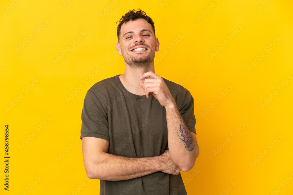 Young caucasian handsome man isolated on yellow background laughing Young caucasian handsome man isolated on yellow background laughing