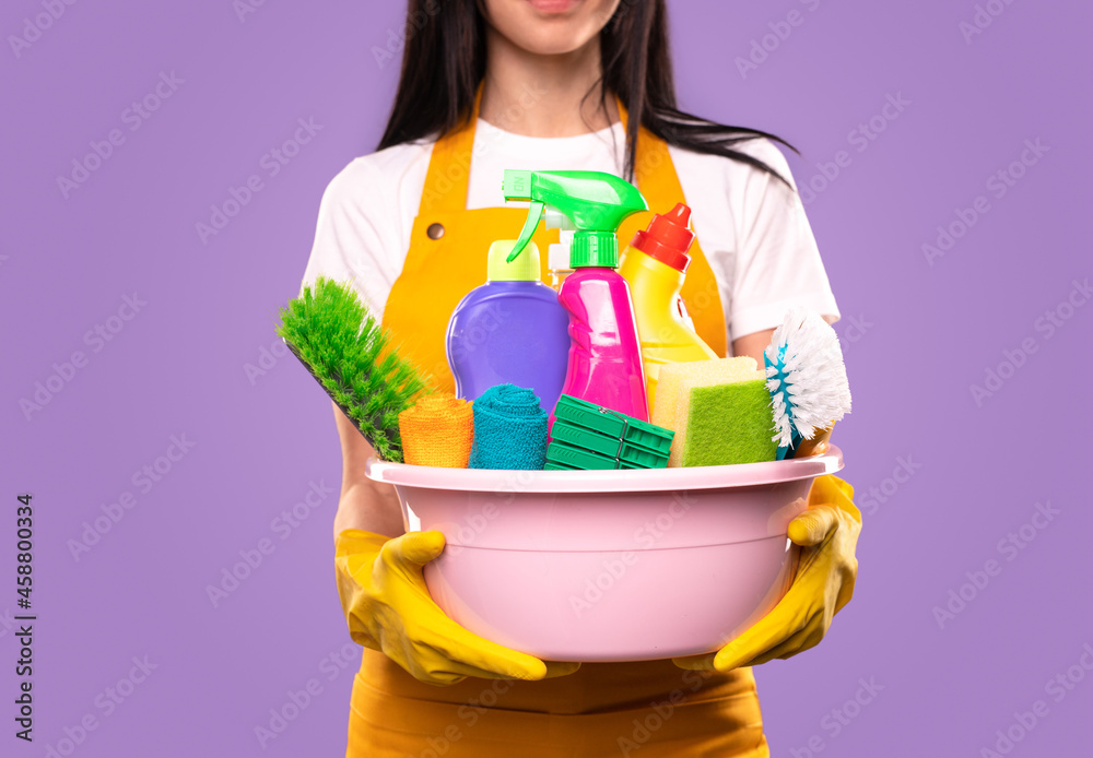 Housekeeper with detergents and cleaning supplies Housekeeper with detergents and cleaning supplies
