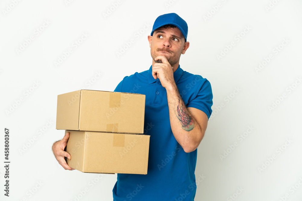 Delivery caucasian man isolated on white background having doubts and thinking Delivery caucasian man isolated on white background having doubts and thinking