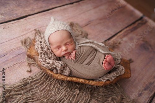 Sleeping newborn boy in the first days of life. Newborn photo session.