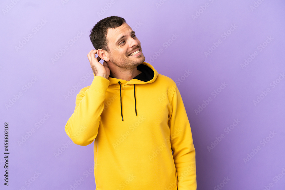 Brazilian man over isolated purple background thinking an idea Brazilian man over isolated purple background thinking an idea