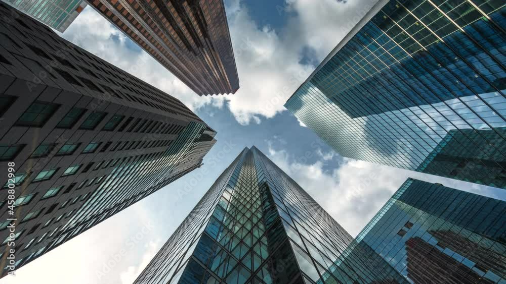 Business and finance concept, time lapse sequence looking up at modern office building architecture in the financial district of Toronto, Ontario, Canada, North America. Business and finance concept, time lapse sequence looking up at modern office building architecture in the financial district of Toronto, Ontario, Canada, North America.