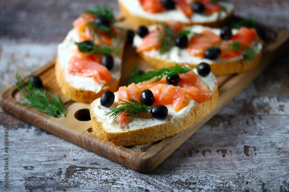 Sandwiches with salmon, cream cheese and olives. Healthy food.
