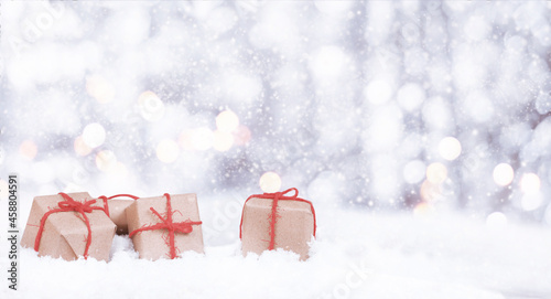 christmas presents and fir in the snow with bokeh and copy space