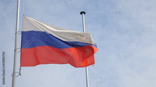Russian flag waving in wind with sky and clouds in background. National flag of Russia. Moscow Flag Blowing Close Up. 4 k video photo