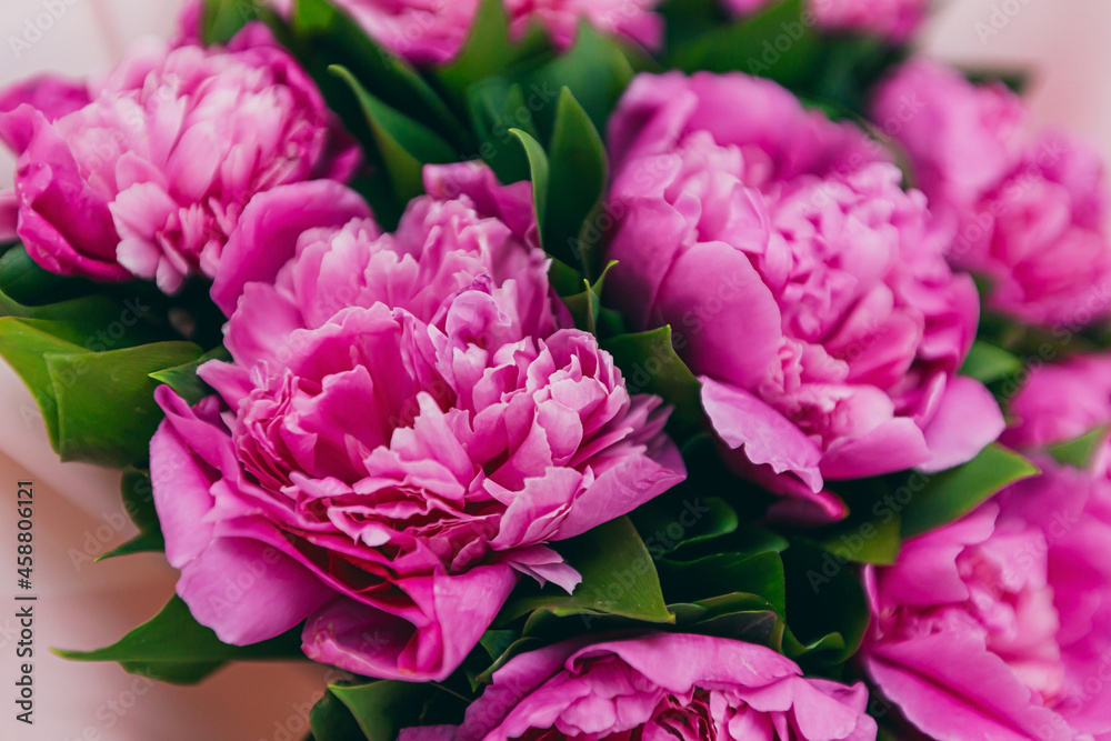 background texture with a bouquet of pink peonies