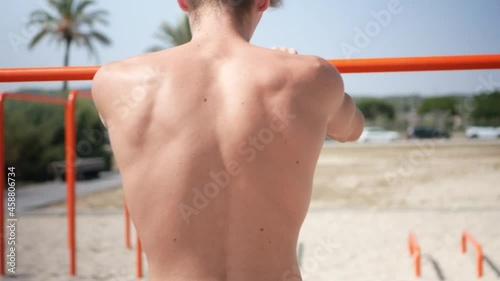 Young man warming up his arms before calisthenics workout. photo