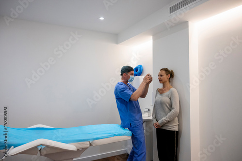Aesthetic surgeon taking photograph of patient before operation photo