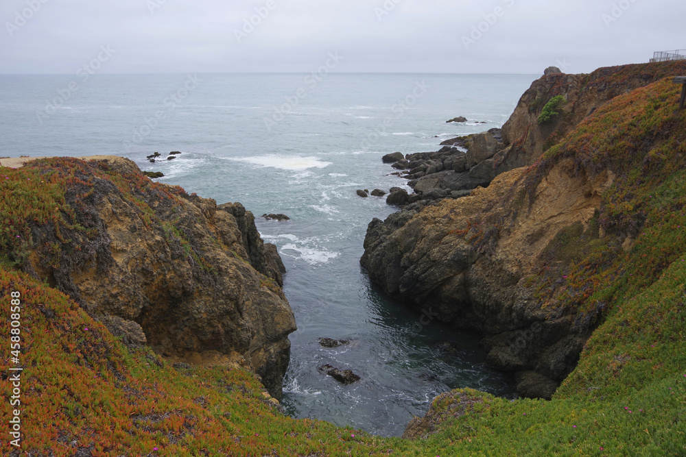 Cliffs and rocks at the rough and wild central California Pacific ocean coast around pigeon point on a foggy summer day
