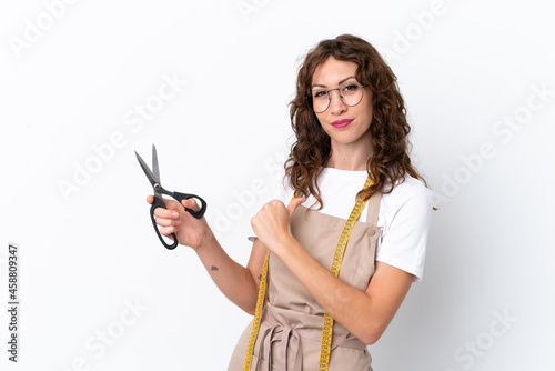 Young caucasian seamstress woman isolated on white background proud and self-satisfied