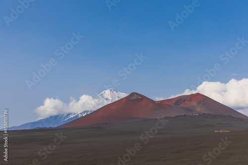 Volcanic-lunar landscape in Kamchatka  rocks from volcanic rocks against the background of a blue sky with clouds. Klyuchevskaya group of volcanoes. 