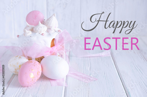 Greeting Easter card. Easter cake, eggs with a congratulatory inscription on a light wooden background.