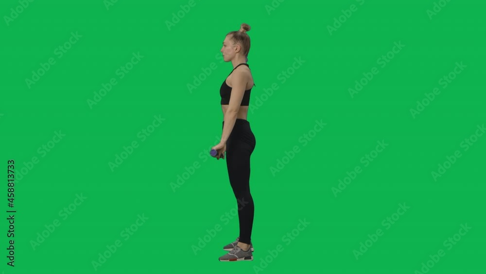 Young woman does exercises, squats with bar. Workout for legs and arms, fitness for women. Online training at home. Side view full length on green screen background. Slow motion ready 59.94fps. Young woman does exercises, squats with bar. Workout for legs and arms, fitness for women. Online training at home. Side view full length on green screen background. Slow motion ready 59.94fps.