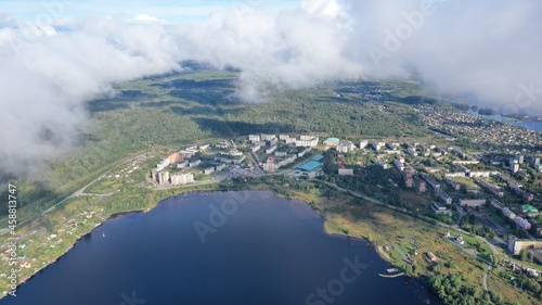 Aerial view of the city. Town. Houses. Lake. Clouds. City of Kondopoga drone shooting. © kareliatim