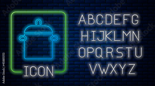 Glowing neon Cooking pot icon isolated on brick wall background. Boil or stew food symbol. Neon light alphabet. Vector