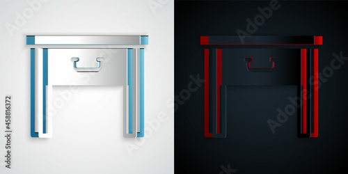 Paper cut Furniture nightstand icon isolated on grey and black background. Paper art style. Vector