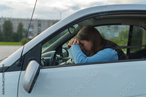 Broken off side rearview mirror on car. Driver woman sad after accident.