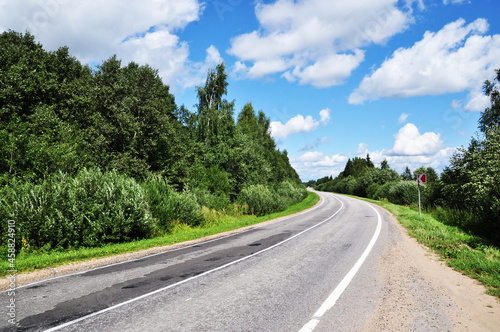 Panoramic view of a deserted road. Hit the road. Beautiful clouds in the sky.