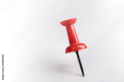 Red pin isolated on white background.