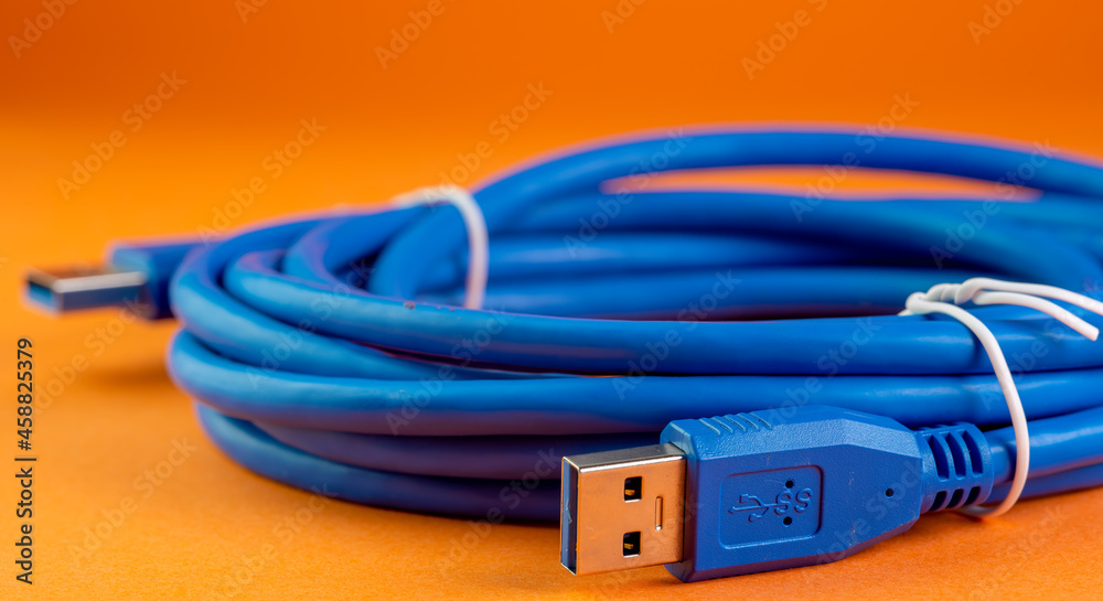 USB cable on orange background USB cable on orange background