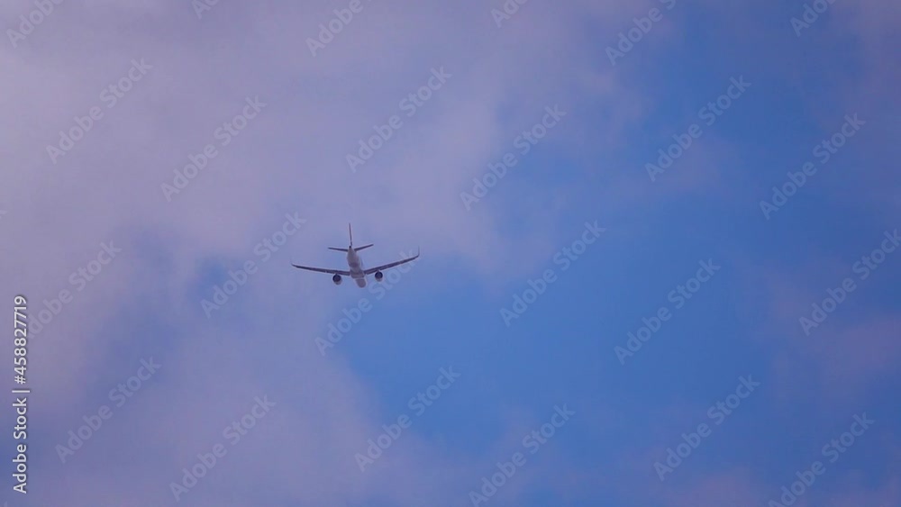Airplane flies down on the clouds. Passenger jet plane in the sky moving with 4K video resolution Airplane flies down on the clouds. Passenger jet plane in the sky moving with 4K video resolution