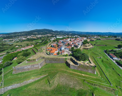 Fortress of Valenca surrounded by greenery under the sunlight and a blue sky in Portuga photo