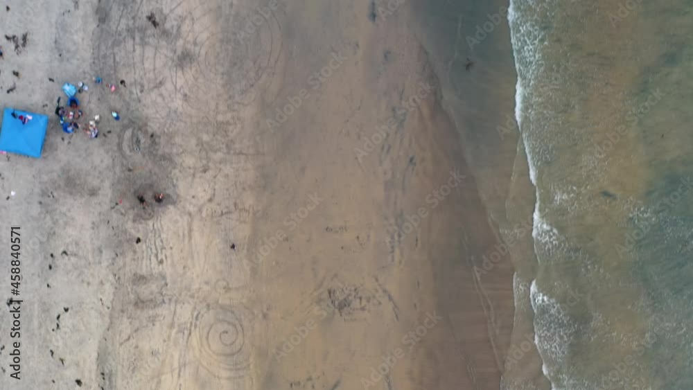 Drone flying fast over beach with people, top down view Drone flying fast over beach with people, top down view