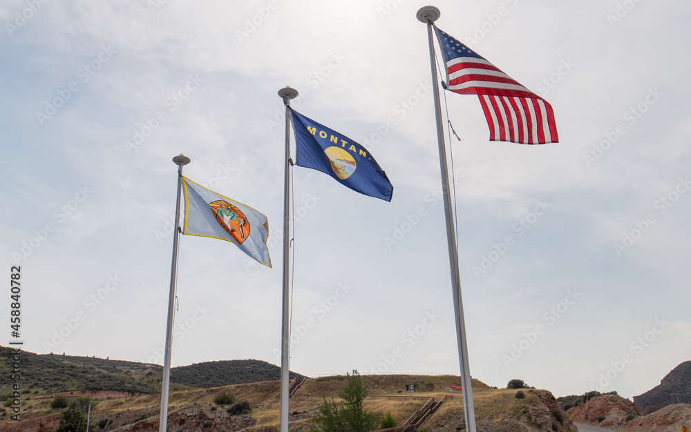 Crow Nation, Montana and United States Flags fly at the Yellowtail Dam recreation park in the Big Horn river canyon
