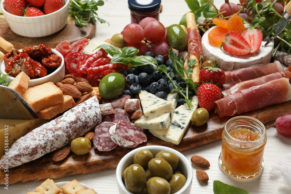 Set of different delicious appetizers served on white wooden table