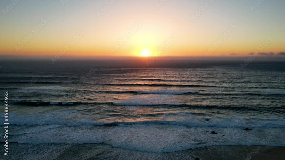 Aerial view of calm sea waves with colorful sunset background - tracking, drone shot Aerial view of calm sea waves with colorful sunset background - tracking, drone shot