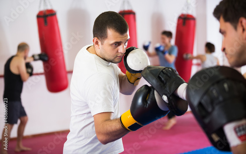 Portrait of two athlete men practicing boxing sparring in gym