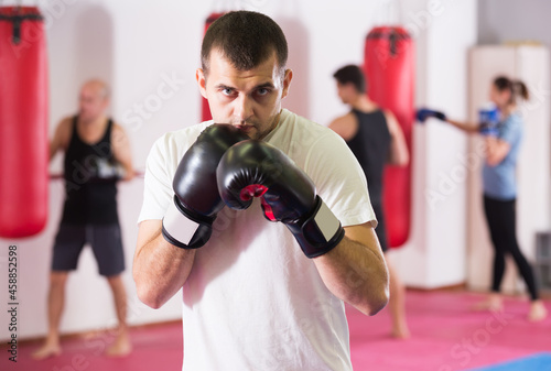 .Portrait of sportsman training in boxing gloves © JackF