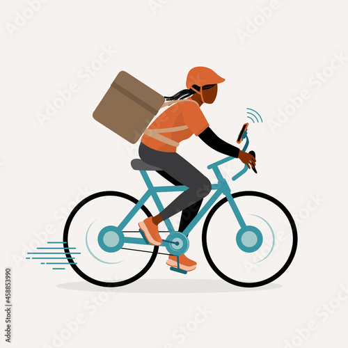 Young Black Delivery Woman With Thermal Insulated Bag Riding Bicycle With Mobile Phone Attached To Bike. Delivery And Logistic Services.
