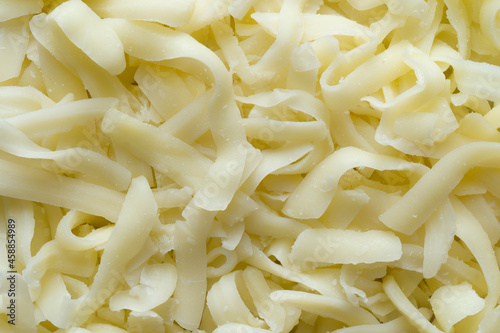 Obraz na płótnie thick cut grated mozzarella cheese food background w salonie