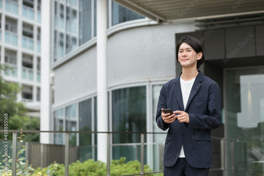 スマートフォンを持つ男性・IoTのイメージ スマートフォンを持つ男性・IoTのイメージ