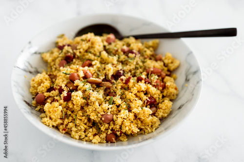 vegan couscous with mixed beans and herbs, healthy plant-based food