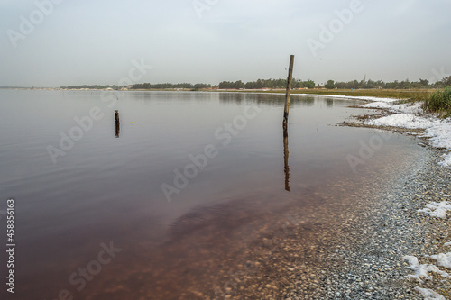 Dakar, Senegal – February 9, 2016 – Lake Retba, also known as Lac Rose (meaning Pink Lake)  , is a lake lying north of the Cap Vert peninsula of Senegal, some 30 km north-east of the capital, Dakar.  photo