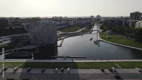 Fly over buildings approaching Ria de Aveiro romantic canals, also know as Portugal Venice.