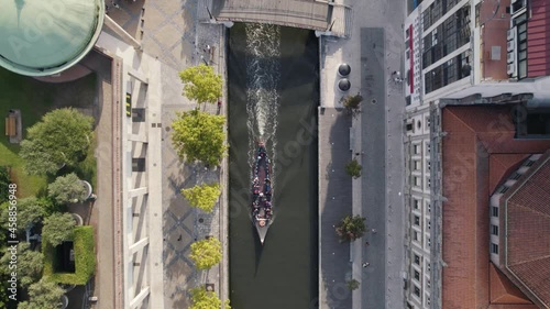 Traditional boat Molicerio cruising on canal of Ria de Aveiro, Portugal. Touristic attraction. Top down aerial view