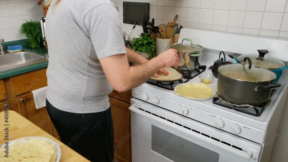 Home cooking - Flipping omelet while being cook on non stick pan preparing for use as wrapping. Home cooking - Flipping omelet while being cook on non stick pan preparing for use as wrapping.