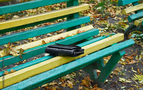 Purse on a bench in the park photo