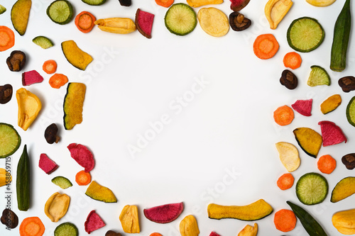 Colorful vegetable chips on white background.