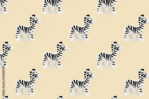Toys seamless pattern. Plastic zebra toy isolated on beige background.