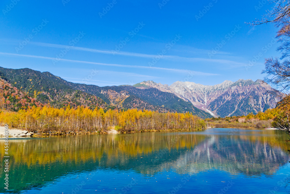 Fototapeta premium Azusa River flowing through Kamikochi national park in Nagano Prefecture, Japan. The autumn leaves season is beautiful.