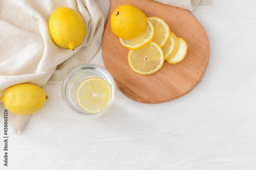Glass with tasty lemonade on light wooden background Glass with tasty lemonade on light wooden background