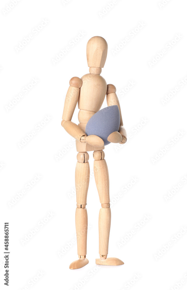 Wooden mannequin with makeup sponge on white background Wooden mannequin with makeup sponge on white background