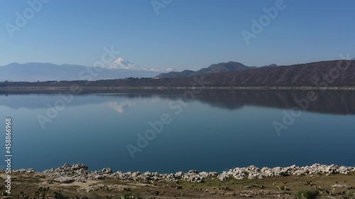 Aerial footage of the Alchichica Lagoon in Puebla, Mexico. Showing Pico de Orizaba in the background photo