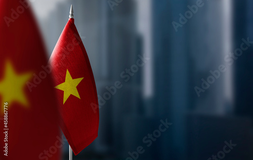 Small flags of Vietnam on a blurry background of the city