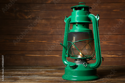Green retro lamp on wooden ...