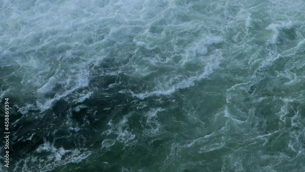 The surface of the water from a bird's eye view. Seething waves on a cloudy day. The surface of the water from a bird's eye view. Seething waves on a cloudy day.